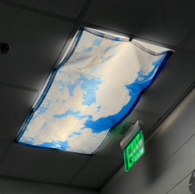 A cloud-themed light diffuser dims the harshness of the fluorescent lighting in Ms. Metsack’s classroom.