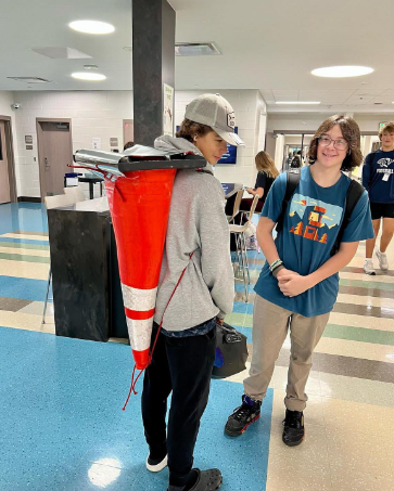 Student wearing a cone as a backpack.